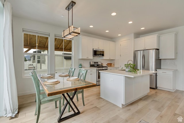 1343 N 3350 W, Provo, UT 84601 - kitchen with stainless steel appliances, light countertops, white cabinets, recessed lighting, and hanging light fixtures