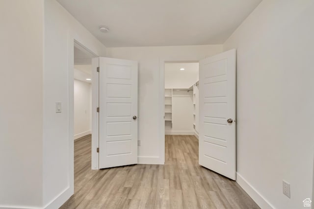 1343 N 3350 W, Provo, UT 84601 - unfurnished bedroom with a walk in closet, light wood-style flooring, baseboards, a closet, and recessed lighting