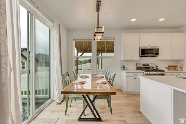 1343 N 3350 W, Provo, UT 84601 - kitchen with appliances with stainless steel finishes, light wood finished floors, light countertops, white cabinets, and recessed lighting