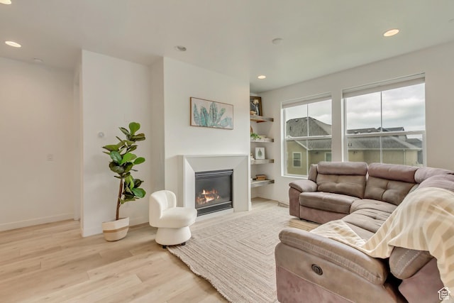 1343 N 3350 W, Provo, UT 84601 - living room with light wood-style flooring, a glass covered fireplace, recessed lighting, and baseboards