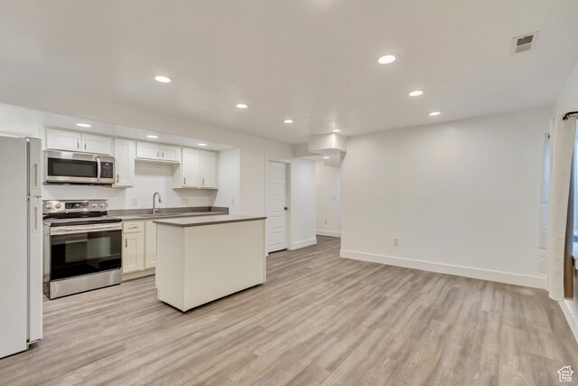 1343 N 3350 W, Provo, UT 84601 - kitchen with appliances with stainless steel finishes, light wood-style flooring, white cabinetry, baseboards, and recessed lighting