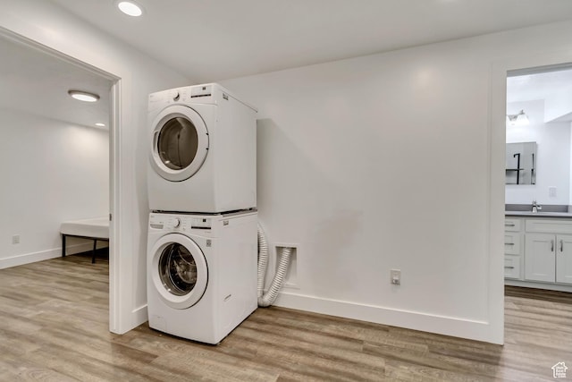 1343 N 3350 W, Provo, UT 84601 - laundry room featuring estacked washer and dryer, light wood finished floors, baseboards, and recessed lighting