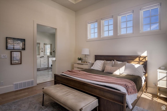 1565 N Overolook Ct, Farmington, UT 84025 - bedroom featuring wood finished floors, ensuite bathroom, and baseboards