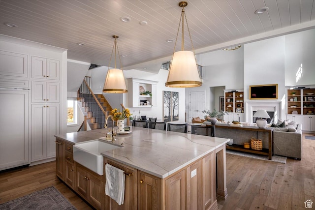 1565 N Overolook Ct, Farmington, UT 84025 - kitchen with wood ceiling, open floor plan, light wood finished floors, a sink, and light stone counters