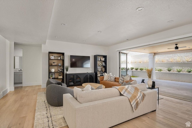 1565 N Overolook Ct, Farmington, UT 84025 - living area featuring a textured ceiling, light wood-style flooring, and baseboards