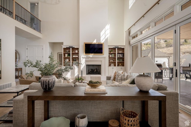 1565 N Overolook Ct, Farmington, UT 84025 - living area featuring a high ceiling, healthy amount of natural light, built in shelves, and wood finished floors