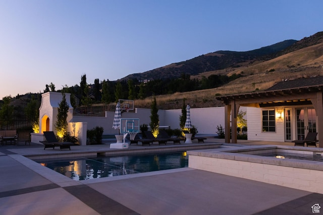 1565 N Overolook Ct, Farmington, UT 84025 - swimming pool featuring a mountain view, a patio area, an in-ground hot tub, and a fireplace