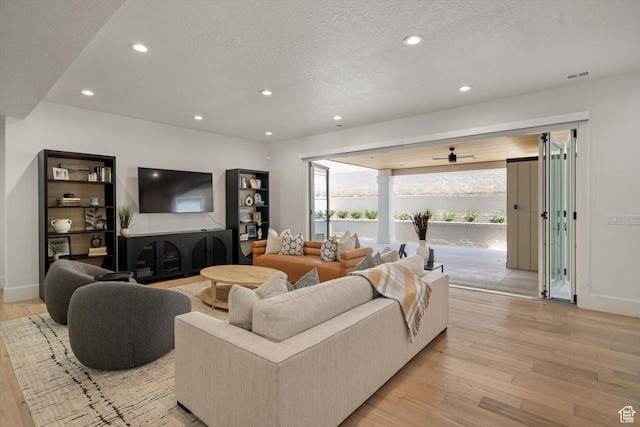 1565 N Overolook Ct, Farmington, UT 84025 - living room featuring light wood-type flooring, a textured ceiling, recessed lighting, ceiling fan, and baseboards
