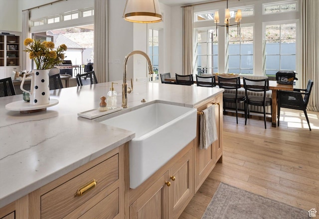 1565 N Overolook Ct, Farmington, UT 84025 - kitchen with a sink, light wood-style flooring, healthy amount of natural light, and hanging light fixtures