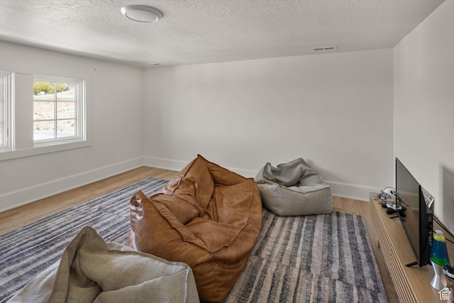 1565 N Overolook Ct, Farmington, UT 84025 - living area featuring wood finished floors, a textured ceiling, and baseboards