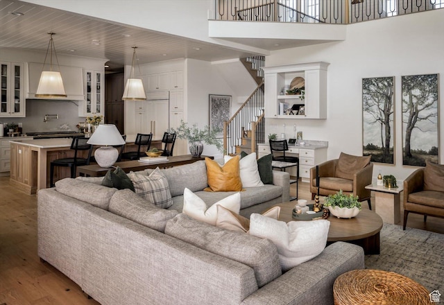 1565 N Overolook Ct, Farmington, UT 84025 - living area with light wood-type flooring, stairway, recessed lighting, and a towering ceiling