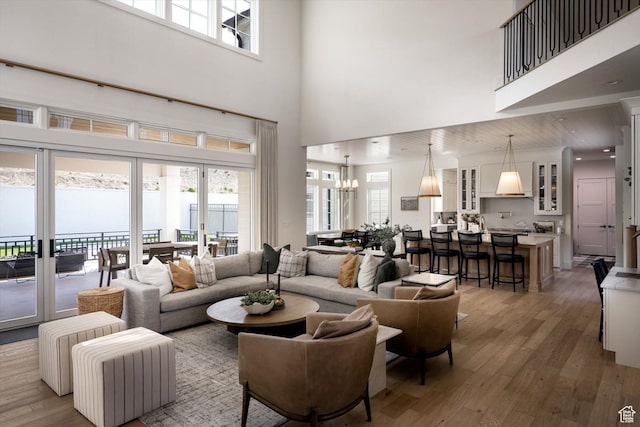 1565 N Overolook Ct, Farmington, UT 84025 - living area with a towering ceiling, wood finished floors, and a chandelier