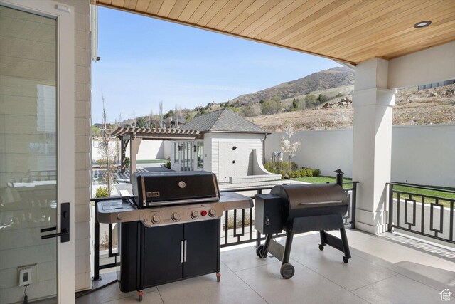 1565 N Overolook Ct, Farmington, UT 84025 - view of patio featuring a mountain view, an outdoor structure, grilling area, a pergola, and fence