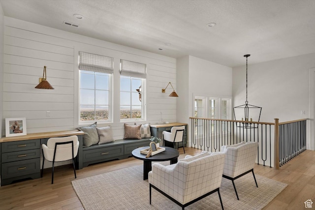 1565 N Overolook Ct, Farmington, UT 84025 - living area featuring light wood finished floors, plenty of natural light, and a textured ceiling