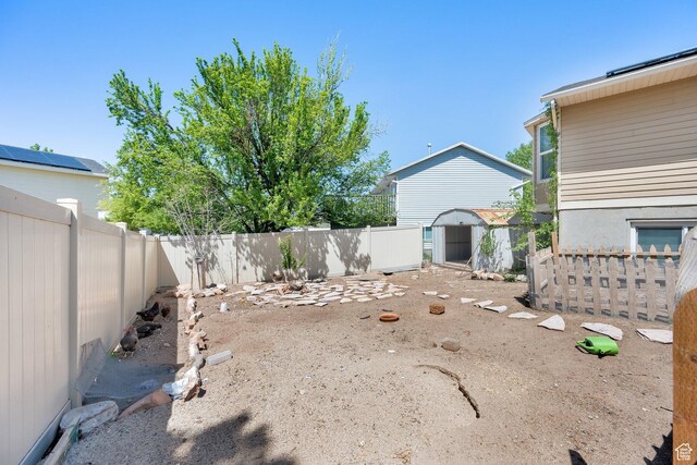 4242 S 6530 W, West Valley City, UT 84128 - fenced backyard with a storage unit and an outbuilding