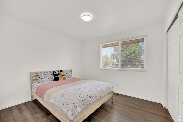 4242 S 6530 W, West Valley City, UT 84128 - bedroom with wood finished floors, a closet, and baseboards