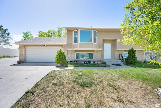 4242 S 6530 W, West Valley City, UT 84128 - raised ranch featuring brick siding, a garage, and concrete driveway