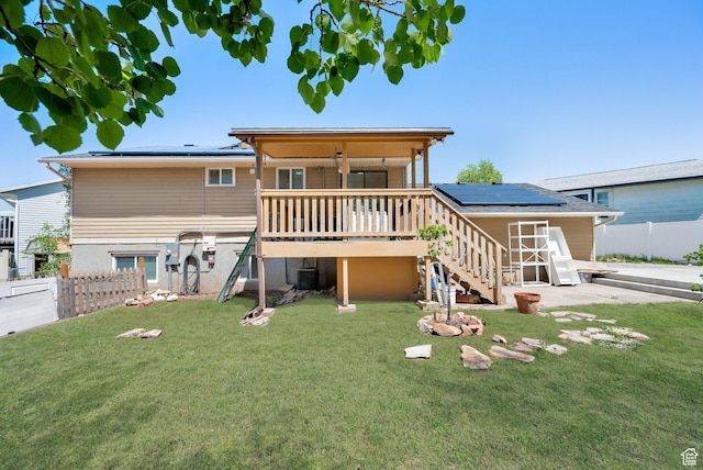 4242 S 6530 W, West Valley City, UT 84128 - back of property featuring solar panels, stairs, a wooden deck, and central AC unit