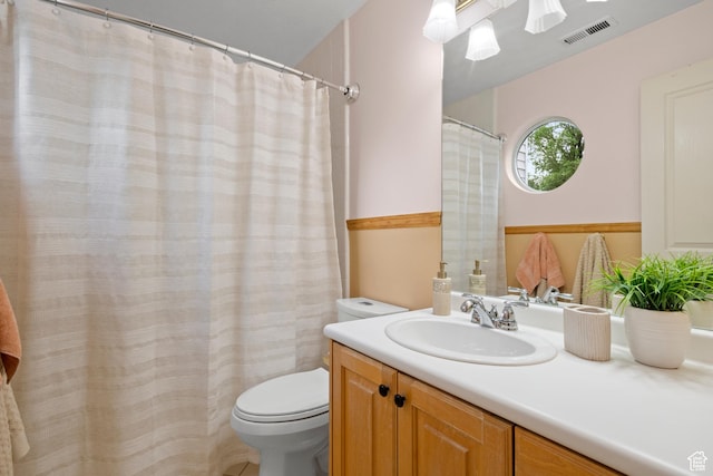 bathroom featuring toilet and vanity
