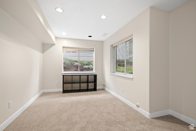 empty room with carpet floors, recessed lighting, and baseboards