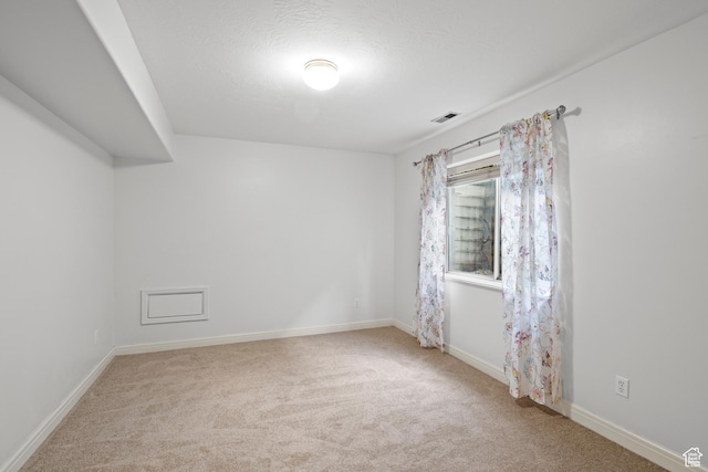 unfurnished room with carpet flooring and baseboards