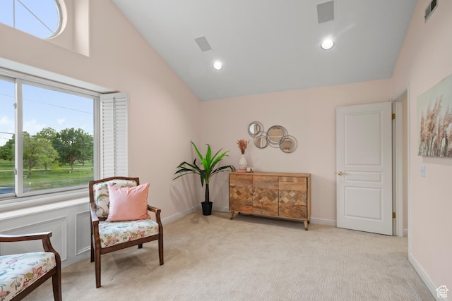 living area with light carpet, recessed lighting, and high vaulted ceiling