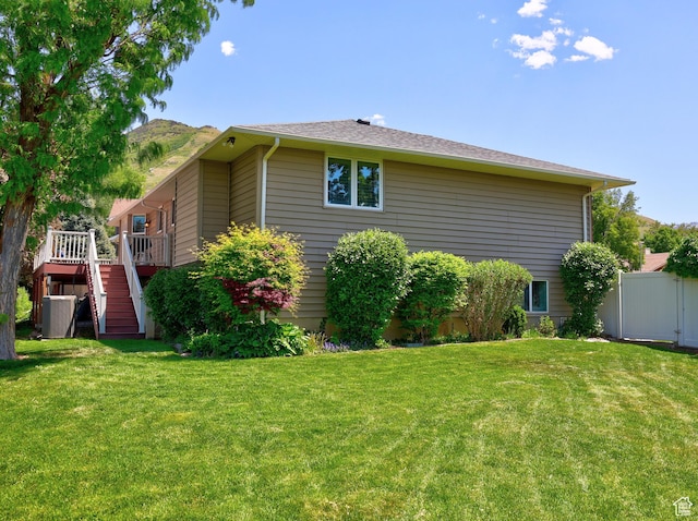 view of property exterior featuring stairway, a wooden deck, and central AC unit