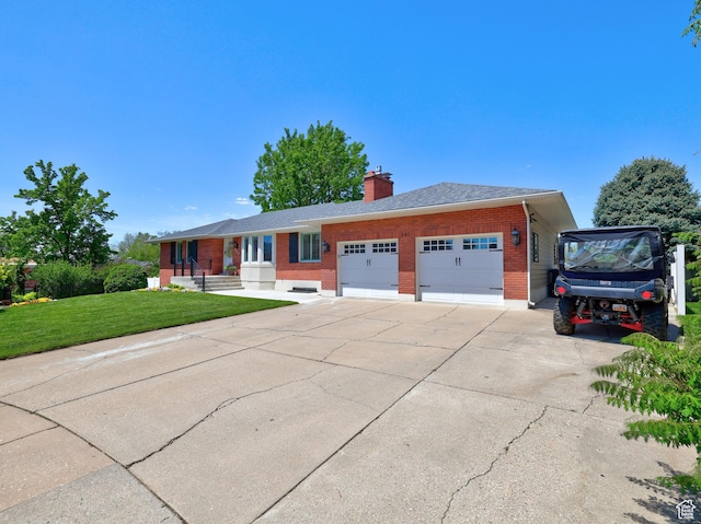 single story home with brick siding, an attached garage, a front lawn, a chimney, and concrete driveway