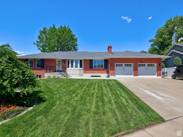 single story home with brick siding, a garage, concrete driveway, and a chimney