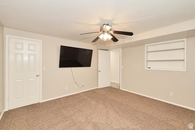 unfurnished bedroom with carpet, baseboards, and a ceiling fan
