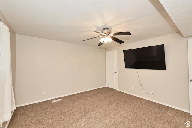 unfurnished living room featuring carpet floors, a ceiling fan, baseboards, and a textured ceiling