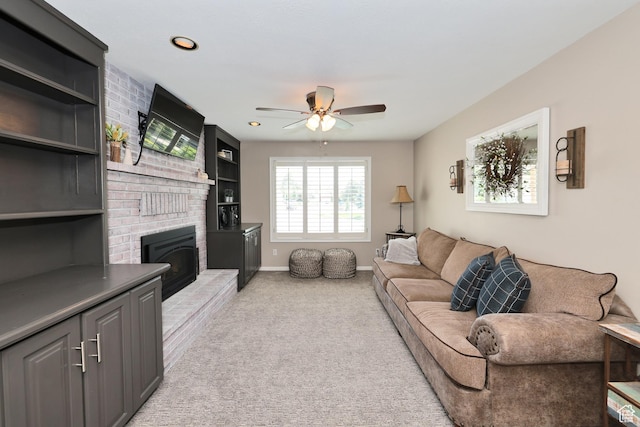 living area featuring ceiling fan, a fireplace, light colored carpet, baseboards, and recessed lighting