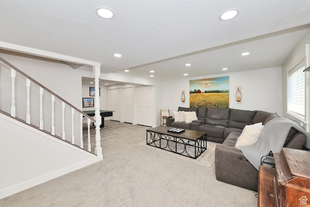 carpeted living area featuring recessed lighting and stairway