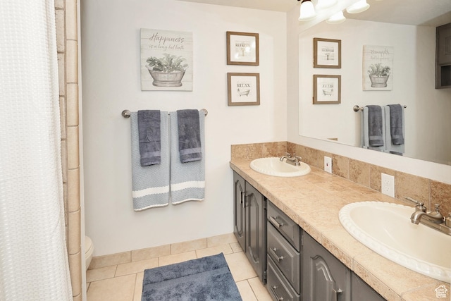 bathroom with double vanity, tile patterned floors, toilet, and a shower with curtain