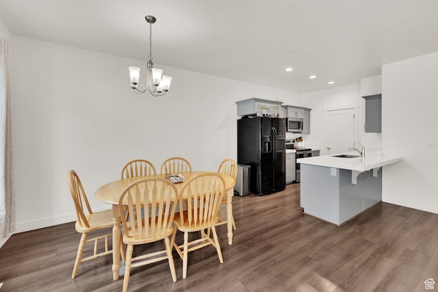 dining room featuring a chandelier, dark wood finished floors, recessed lighting, and baseboards