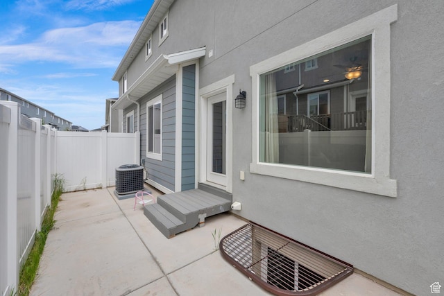 view of patio with fence and central AC unit