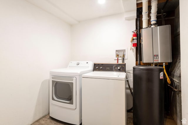 laundry room featuring washing machine and dryer and light wood-style flooring