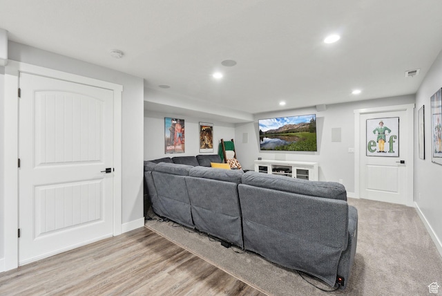 living room featuring recessed lighting, baseboards, and light wood-style flooring