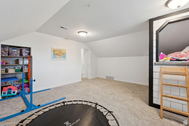 recreation room with vaulted ceiling, carpet floors, and baseboards