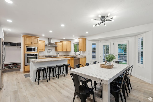 dining space featuring light wood finished floors, recessed lighting, a chandelier, and baseboards