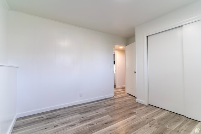 4740 S 3040 W, Taylorsville, UT 84129 - unfurnished bedroom with light wood-type flooring, a closet, and baseboards