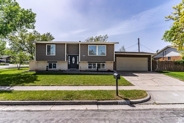 4740 S 3040 W, Taylorsville, UT 84129 - bi-level home with an attached garage, brick siding, and driveway