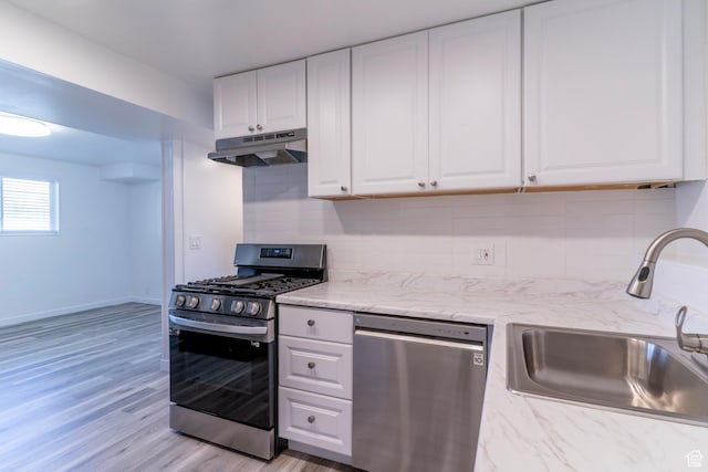 4740 S 3040 W, Taylorsville, UT 84129 - kitchen featuring stainless steel appliances, a sink, under cabinet range hood, white cabinets, and decorative backsplash