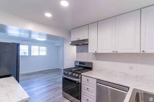 4740 S 3040 W, Taylorsville, UT 84129 - kitchen featuring appliances with stainless steel finishes, under cabinet range hood, white cabinetry, backsplash, and recessed lighting