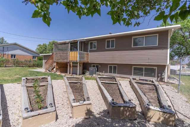 4740 S 3040 W, Taylorsville, UT 84129 - rear view of house featuring a vegetable garden, central AC, stairs, and a wooden deck