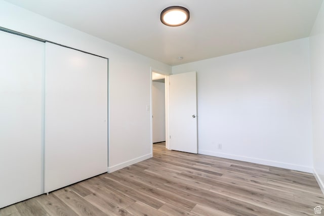 4740 S 3040 W, Taylorsville, UT 84129 - unfurnished bedroom featuring light wood finished floors, baseboards, and a closet