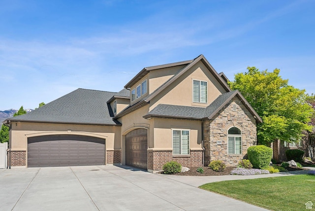 1737 S Kerrybrook Dr, Kaysville, UT 84037 - view of front of house featuring concrete driveway, stucco siding, a garage, brick siding, and a shingled roof
