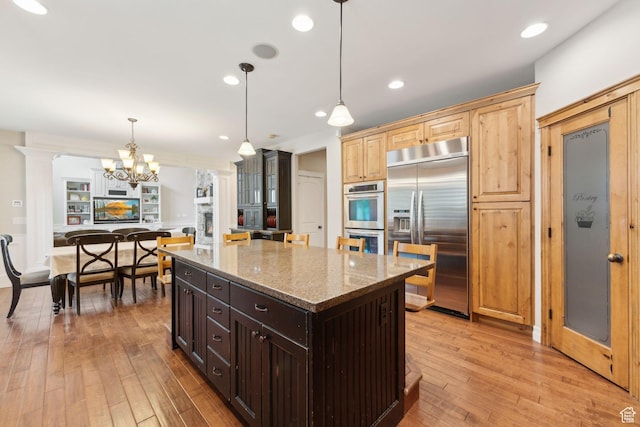 1737 S Kerrybrook Dr, Kaysville, UT 84037 - kitchen featuring stainless steel appliances, light wood-type flooring, light stone countertops, a chandelier, and a kitchen island