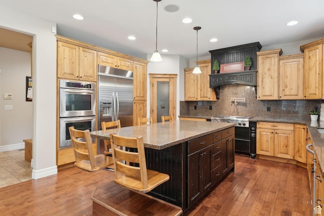 1737 S Kerrybrook Dr, Kaysville, UT 84037 - kitchen with stainless steel appliances, dark stone countertops, a center island, dark wood-style flooring, and tasteful backsplash