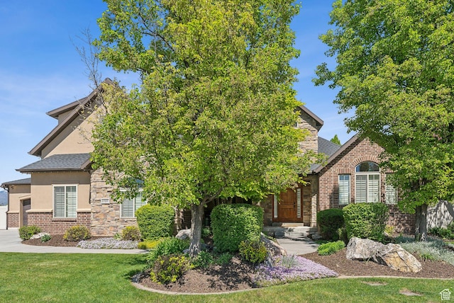 1737 S Kerrybrook Dr, Kaysville, UT 84037 - view of property hidden behind natural elements with stucco siding, a front lawn, stone siding, and brick siding